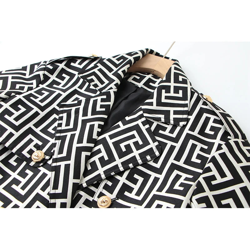 Close-up of the geometric trench coat's notched lapels and gold buttons.