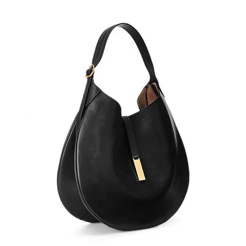 Angled view of a black rounded shoulder bag with an adjustable strap and gold-tone front clasp.