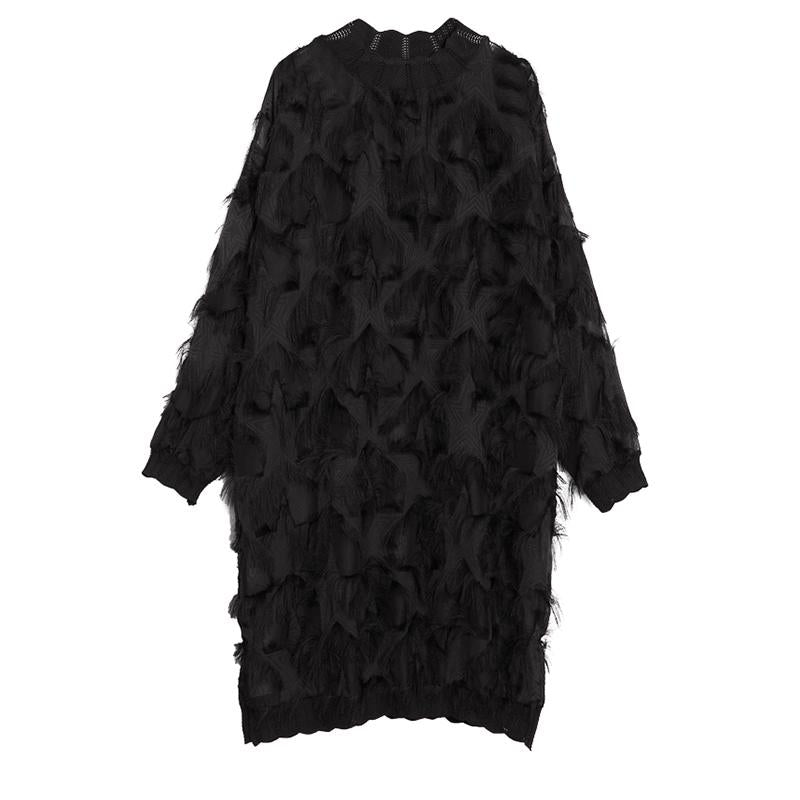 Black long-sleeve high-neck dress with sheer panels, feathery fringe, and scalloped hem, product view.