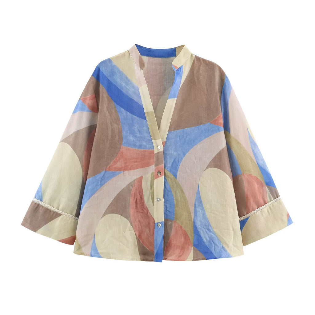 Pastel blue, peach, and cream abstract-print shirt with a V-neck and wide three-quarter sleeves, front view.
