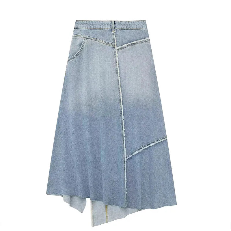 Back view of a light blue denim skirt with frayed diagonal seams and an asymmetric hem.