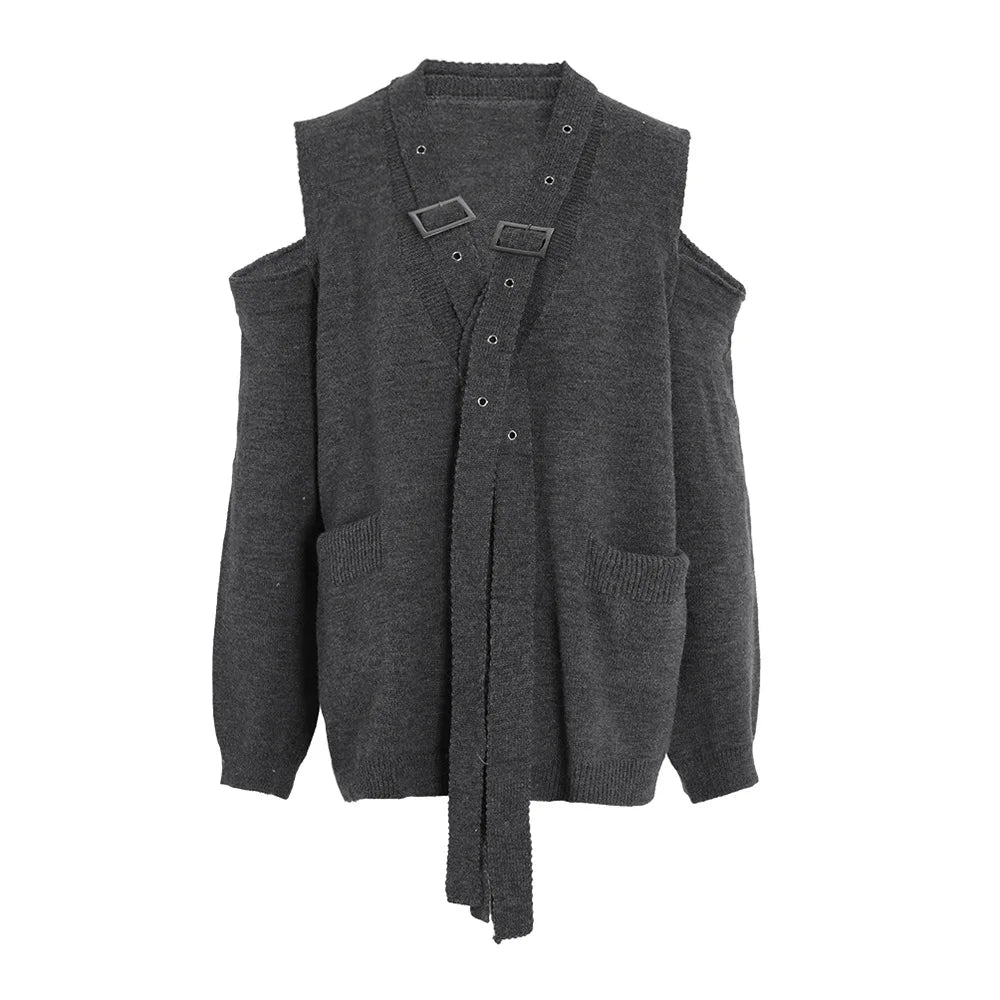 Dark gray cold-shoulder sweater with crossed buckle straps, patch pockets, and ribbed cuffs, front view.