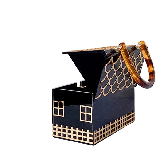 Black house-shaped handbag with its roof lid open, showing the interior and amber patterned handle.
