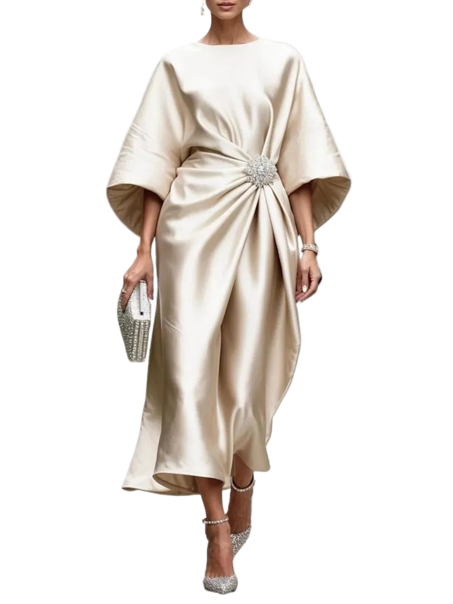 Model wearing a cream satin-look draped midi dress with wide sleeves and a sparkling waist brooch, front view.