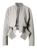 Light gray cropped jacket with a stand collar, layered front, angular hanging panels, and dark piping, front view.