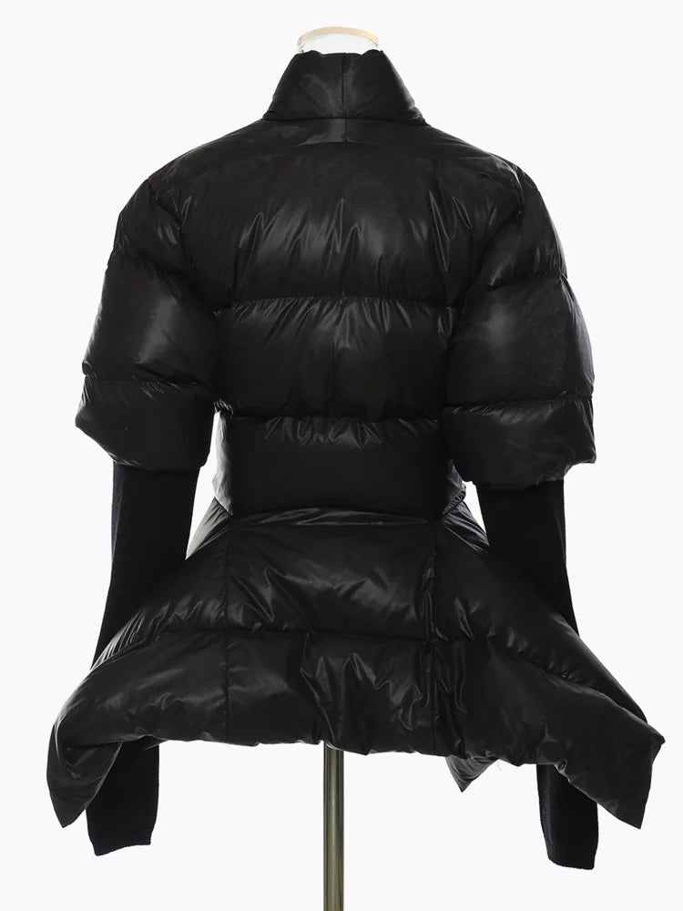 Back view of a black padded jacket with a cinched waist, flared asymmetric hem, and long black cuffs.