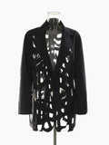Black blazer with notched lapels, geometric cutouts, and solid long sleeves on a clear mannequin, front view.