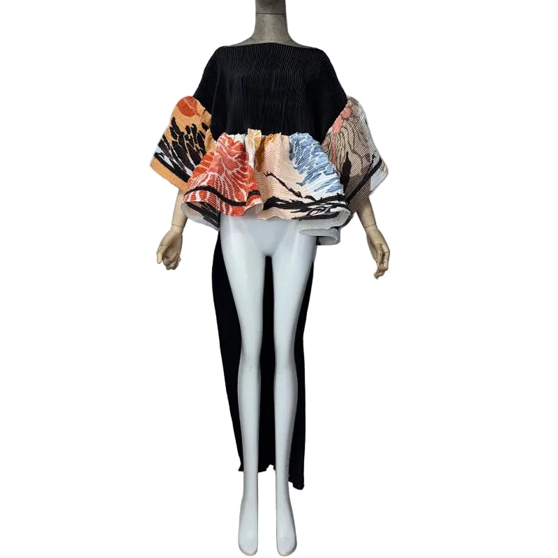 Black and multicolor floral pleated top on a mannequin, showing wide sleeves and a long black back panel.