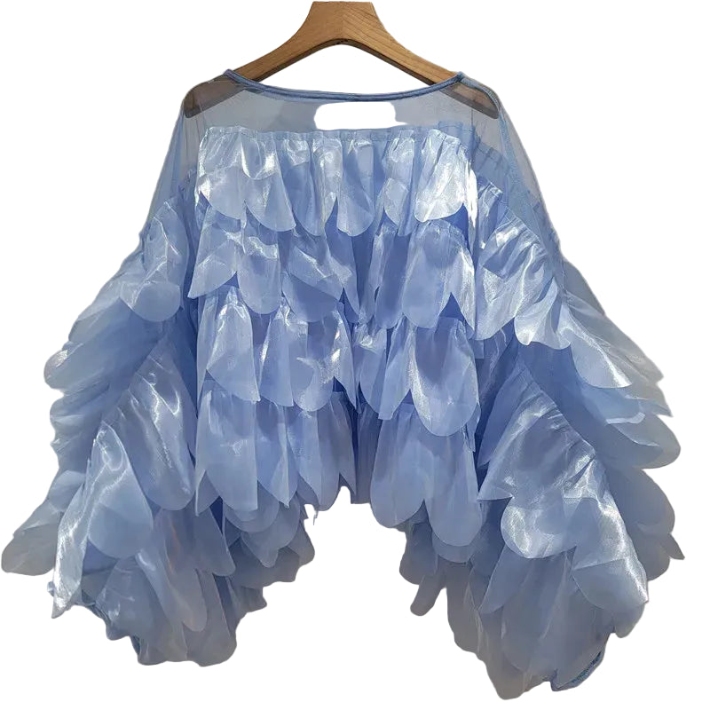 Light blue sheer blouse with layered petal details and wide bell sleeves, hanging front view.