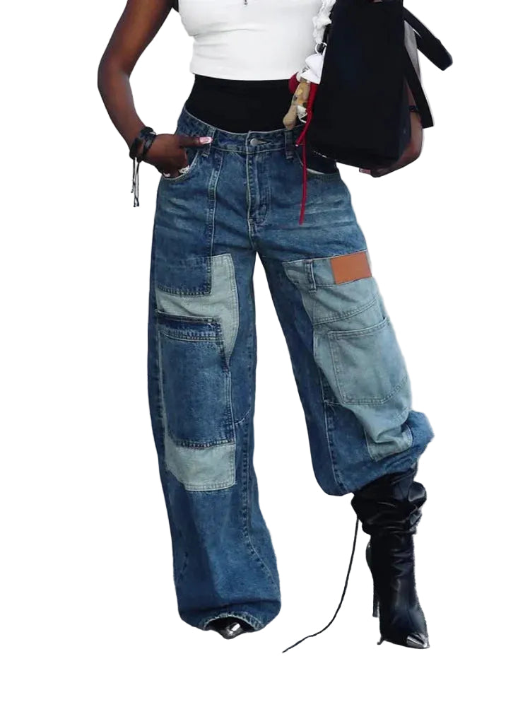 Front view of blue wide-leg jeans with oversized patchwork pockets, worn with black boots.