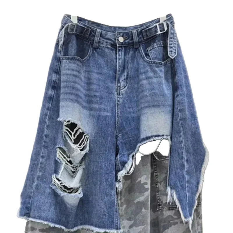 Close-up of distressed blue denim, waist buckles, and gray camouflage inset panels.