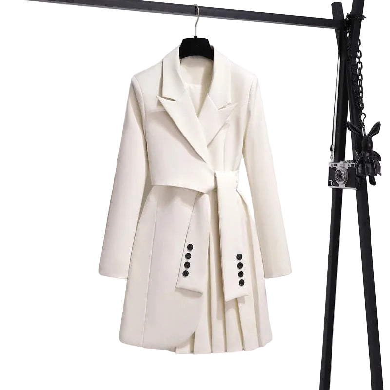 Ivory blazer-style dress with notched lapels, sleeve-like waist ties, and an asymmetric pleated skirt on a hanger.