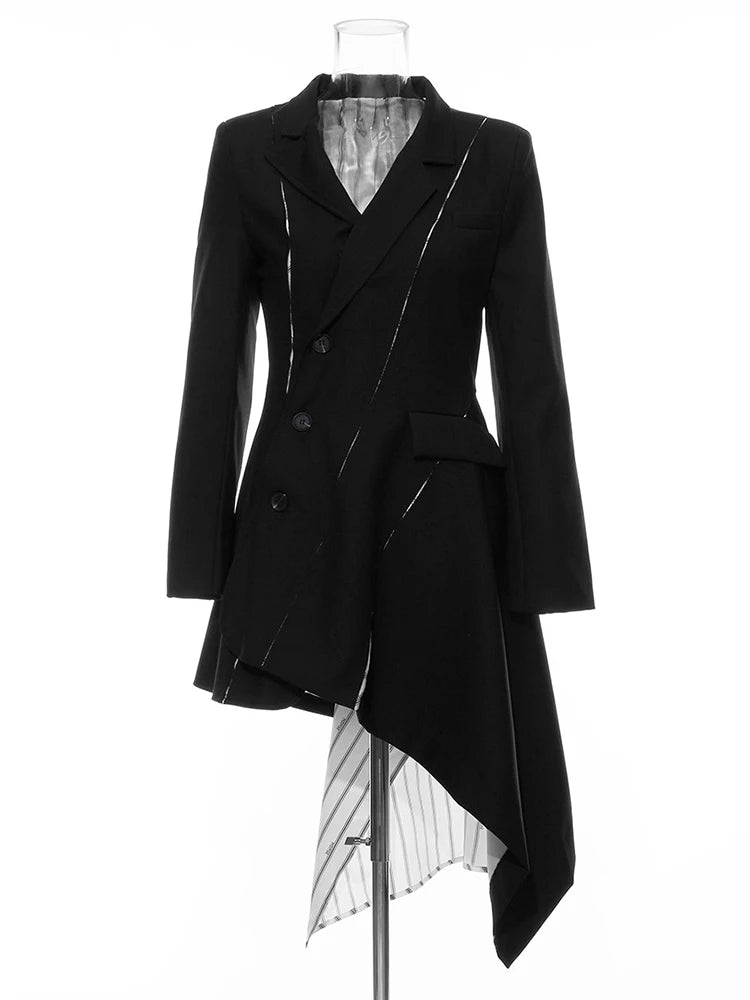 Black asymmetric blazer with slashed accents and a long striped lining panel on a mannequin, front view.