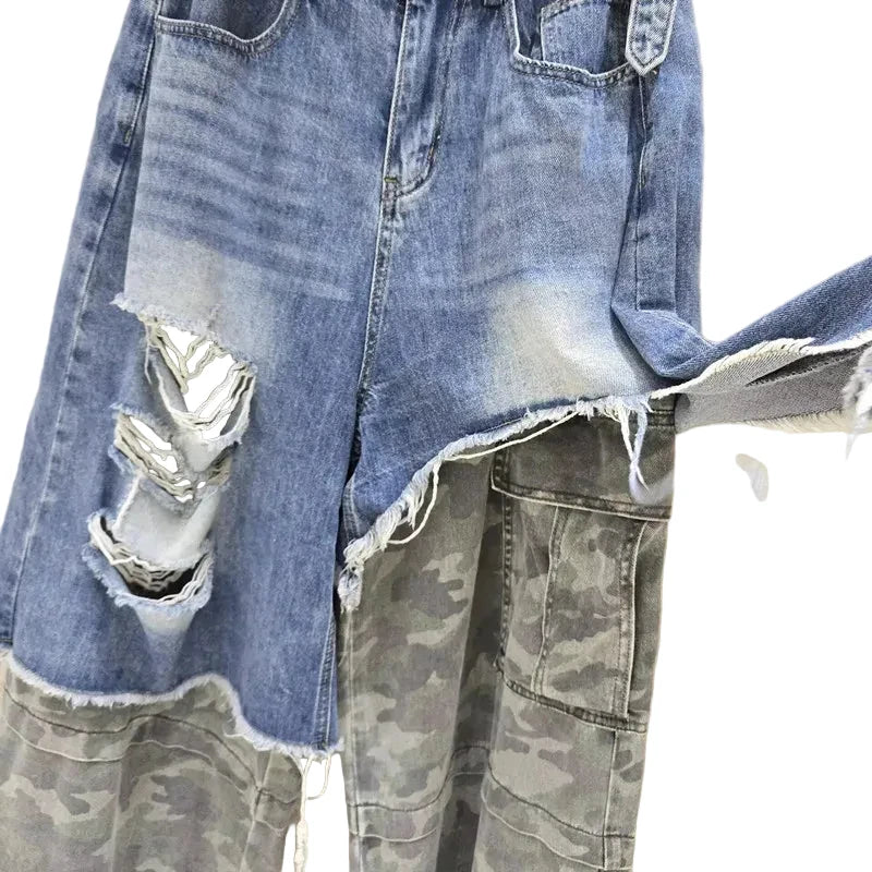 Close-up of ripped denim and the frayed edge above a gray camouflage cargo pocket.