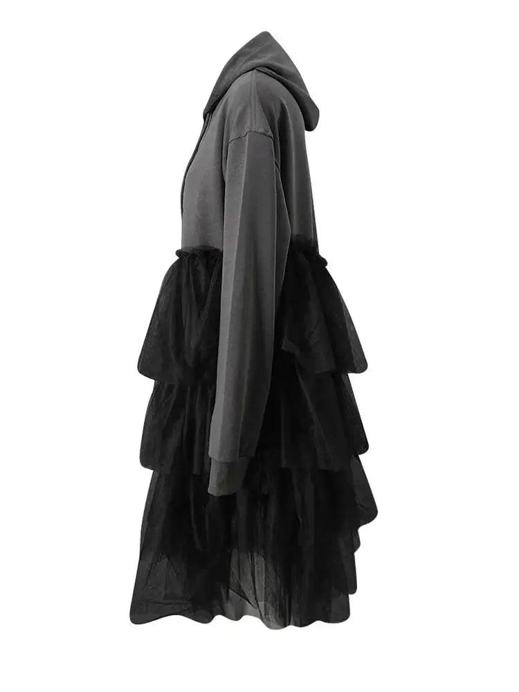 Side view of a gray hooded dress with a black tiered tulle skirt and long sleeves.