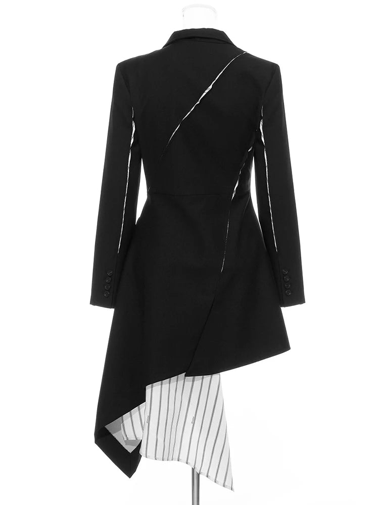 Back view of a black asymmetric blazer with slashed accents, cuff buttons, and a long striped lining panel.