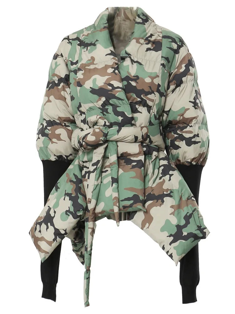 Camouflage padded jacket with wide lapels, a waist tie, pointed hem panels, and long black cuffs, front view.