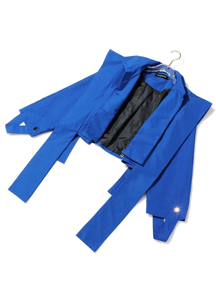 Royal blue cropped jacket laid open, showing black lining, cuff loops, and long hanging front panels.