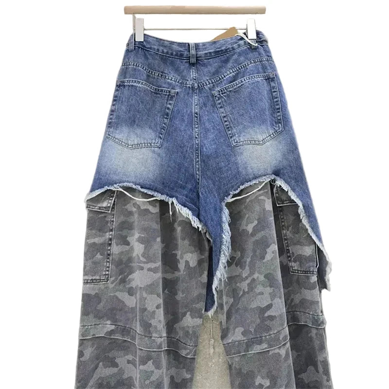 Back view of distressed blue jeans with gray camouflage lower panels, rear denim pockets, and cargo pockets.
