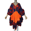 Navy and red floral pleated dress with an orange front panel, puffed sleeves, and irregular hem on a mannequin.
