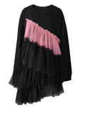 Black crewneck dress with long sleeves and diagonal pink and black tiered tulle ruffles, product view.
