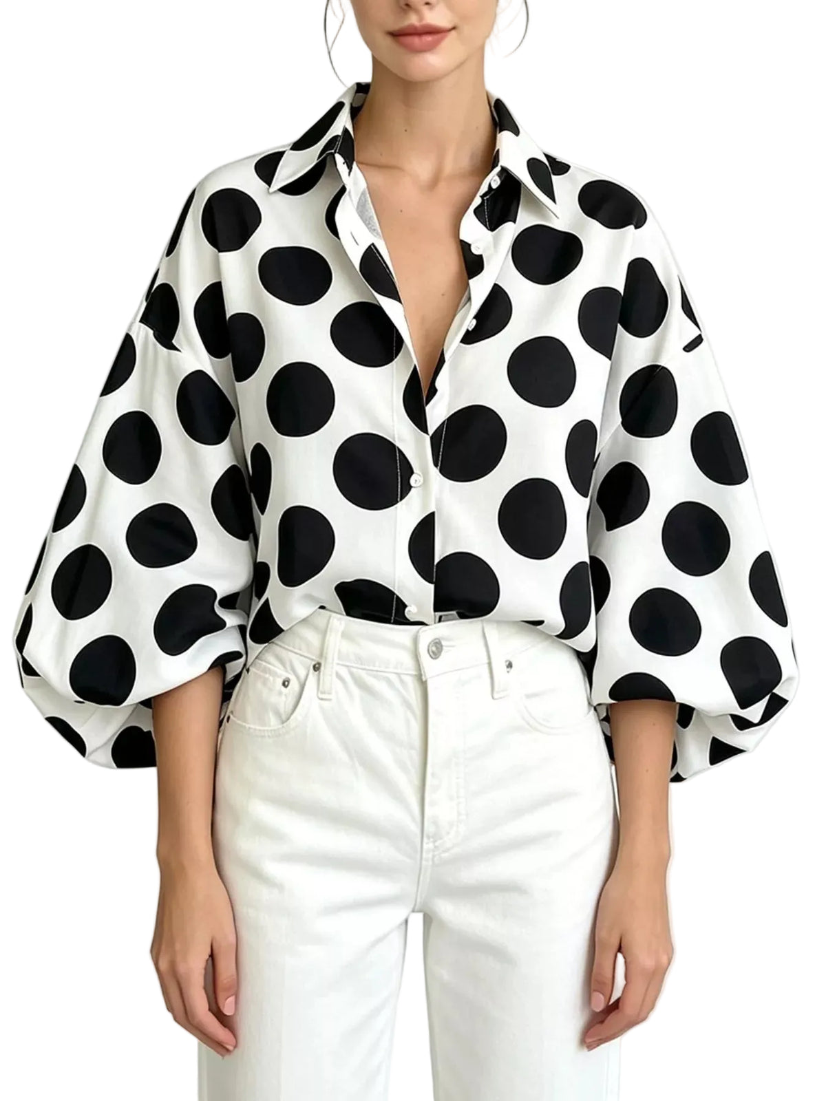 Model wearing a white collared button-front shirt with large black polka dots and puff sleeves, front view.