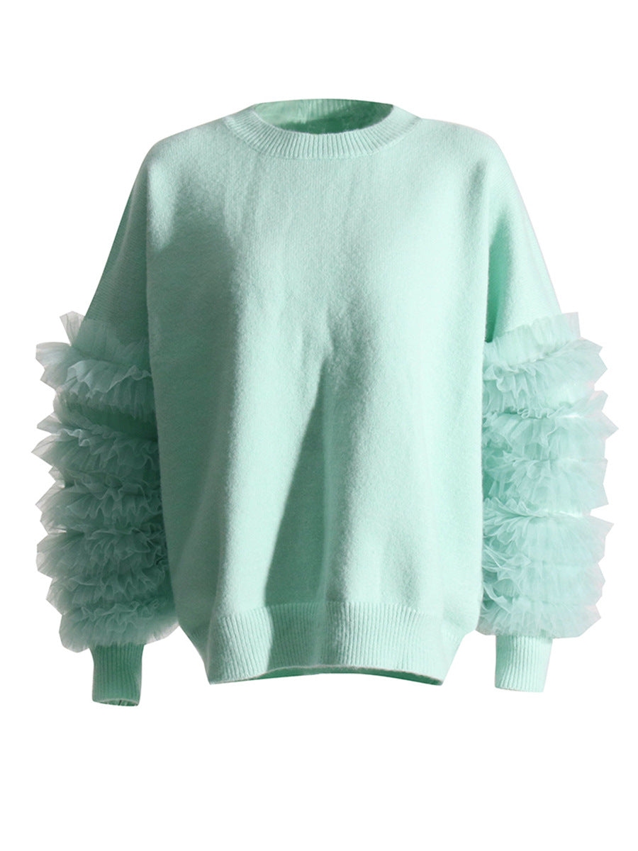 Mint green crewneck sweater with layered sheer ruffles on the sleeves and ribbed cuffs, front view.