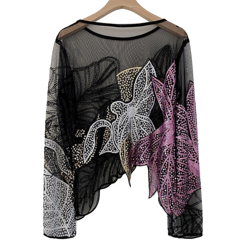 Black sheer long-sleeve top with silver, gold, and purple floral sequins and an irregular hem.