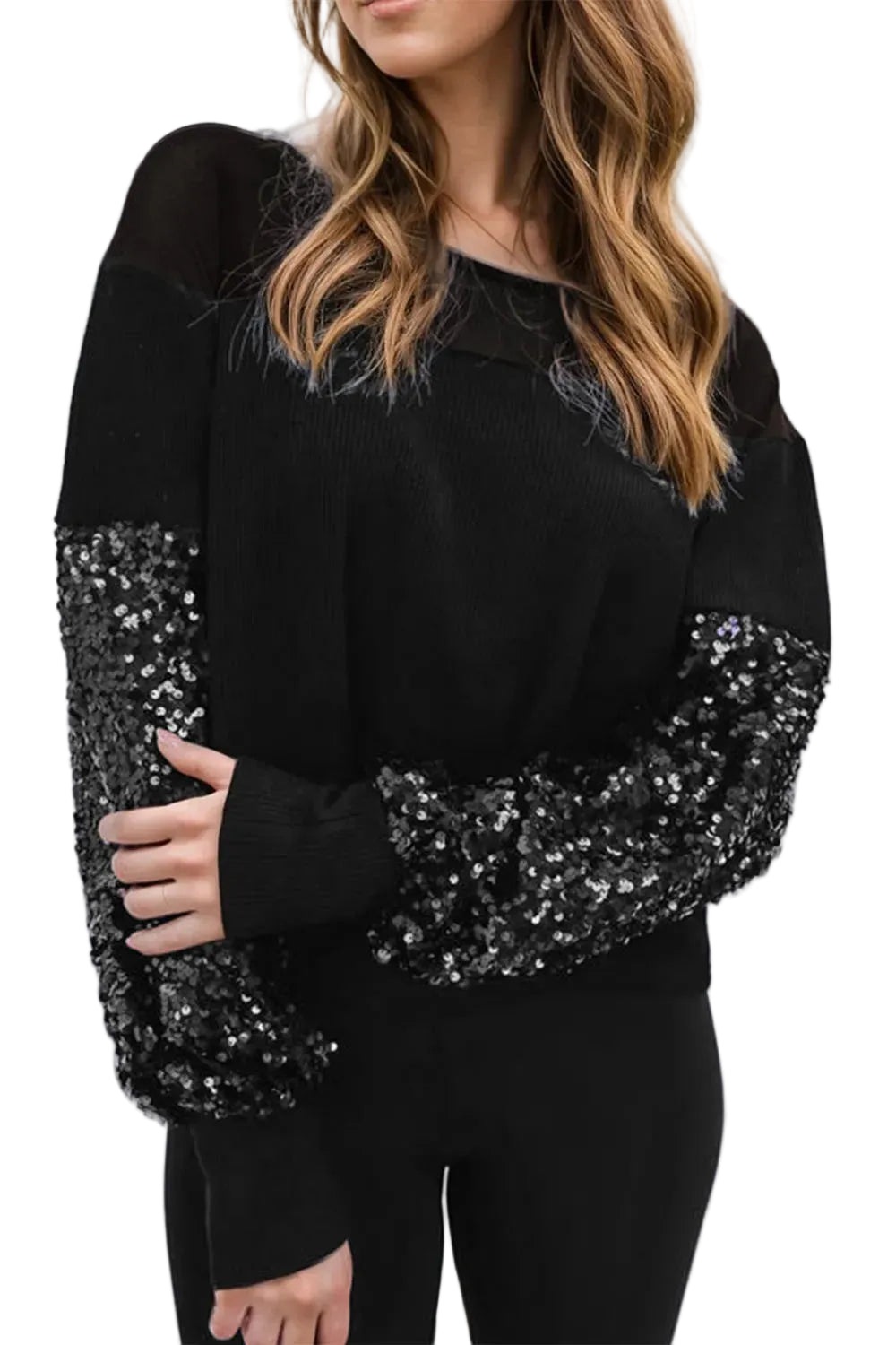 Model wearing a black boat-neck blouse with sequined lower sleeves and black cuffs, front view.