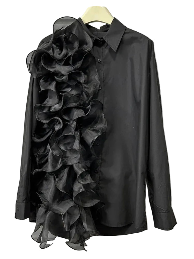 Black long-sleeve collared blouse with cascading sheer ruffles down one side, hanging front view.