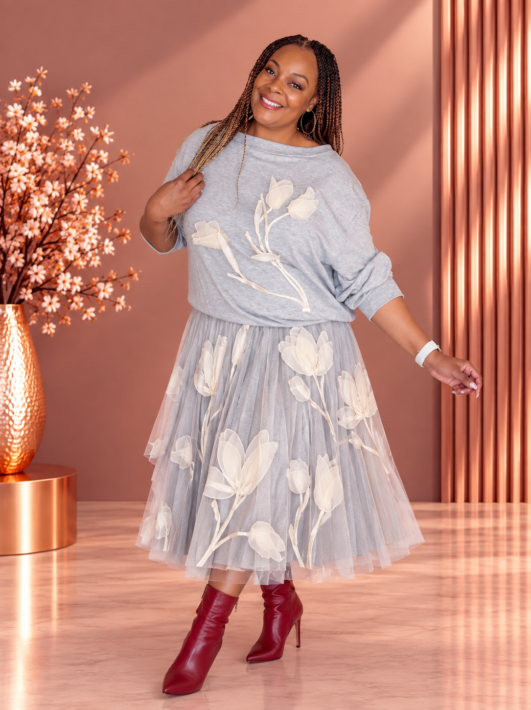 Model wearing a gray sweatshirt with cream floral appliques and a matching floral tulle skirt.