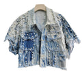 Cropped blue distressed denim top with white stars, pearl-like studs, frayed seams, and flap pockets.