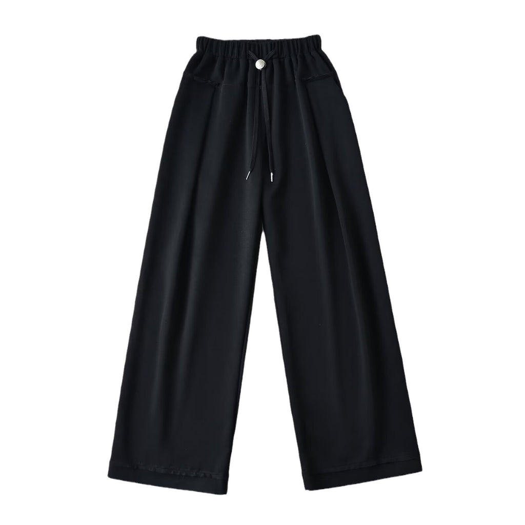 Black wide-leg pants with an elastic waistband, drawstring, silver button, and slanted pockets, front view.