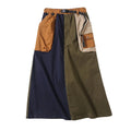 Navy and olive color-block A-line cargo skirt with mustard and beige patch pockets and a buckle belt, front view.