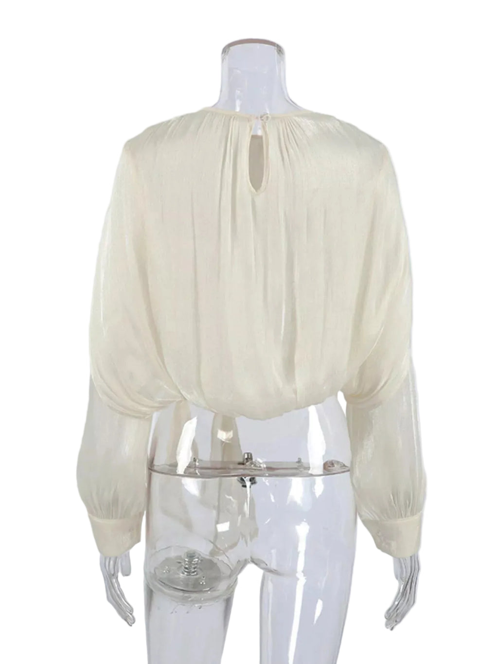Back view of an ivory cropped blouse with a keyhole neckline, balloon sleeves, and gathered hem.
