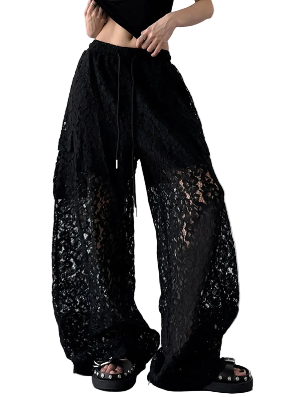 Angled view of black floral lace wide-leg pants showing the sheer legs and drawstring waist.