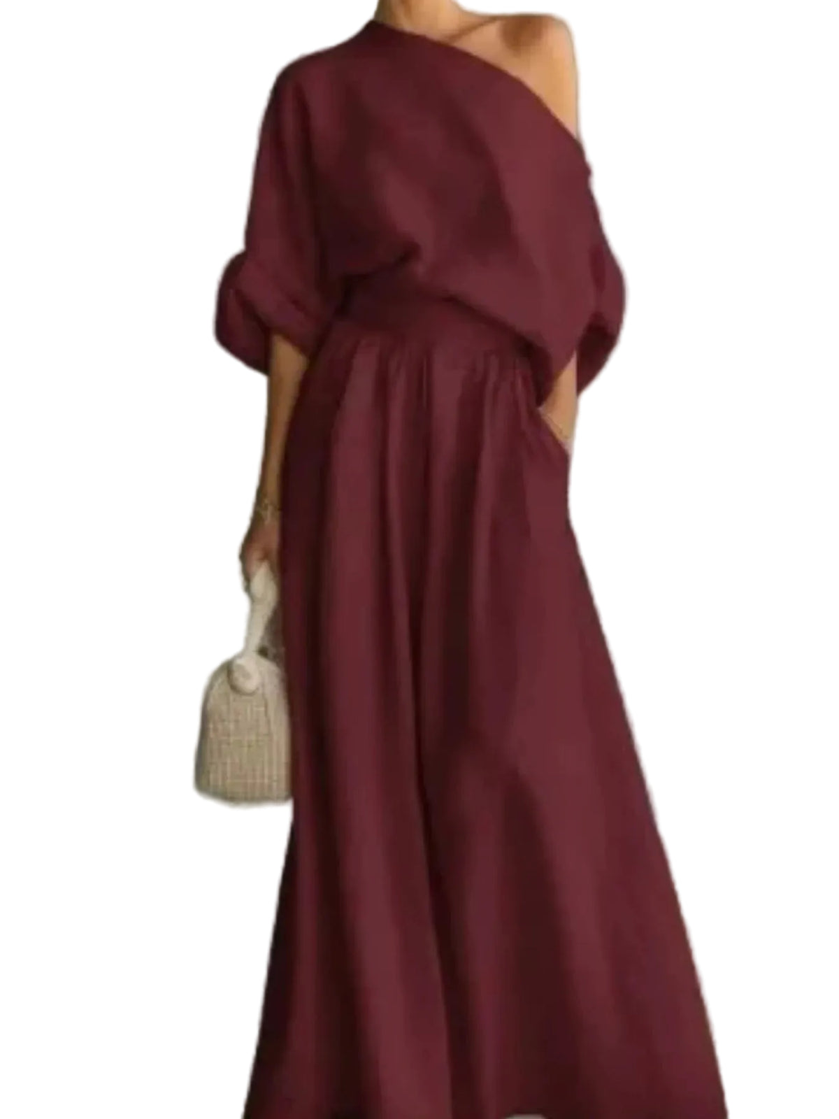 Close-up of a burgundy one-shoulder draped top and matching gathered-waist pants with side pockets.