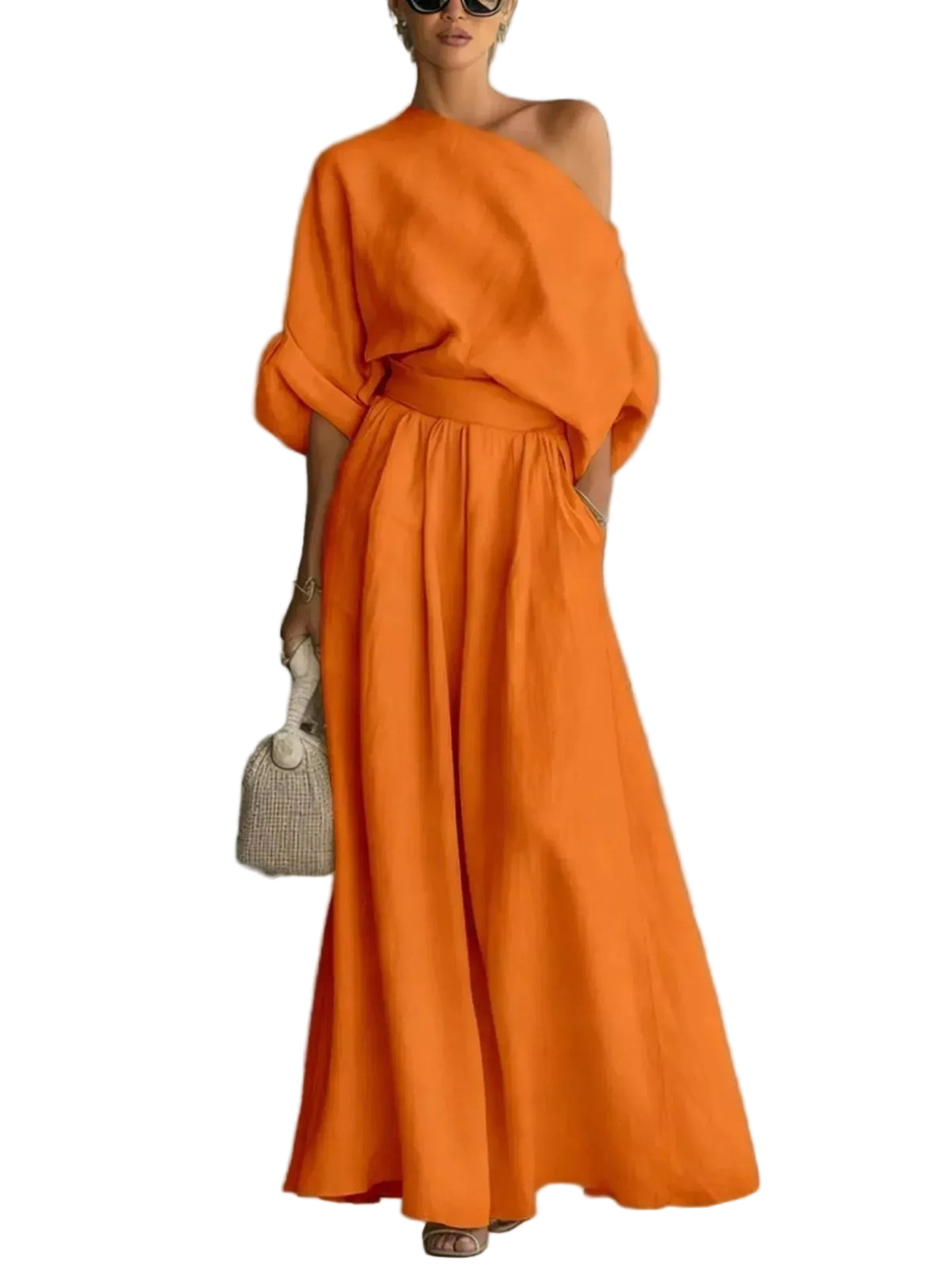 Model wearing an orange one-shoulder draped top and matching gathered-waist wide-leg pants, front view.