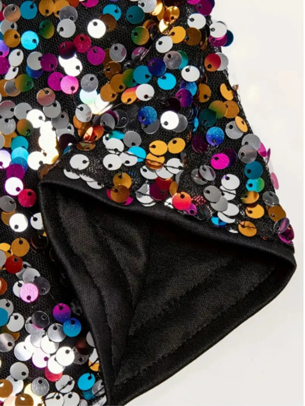 Close-up of the multicolor sequin skirt hem and black lining.