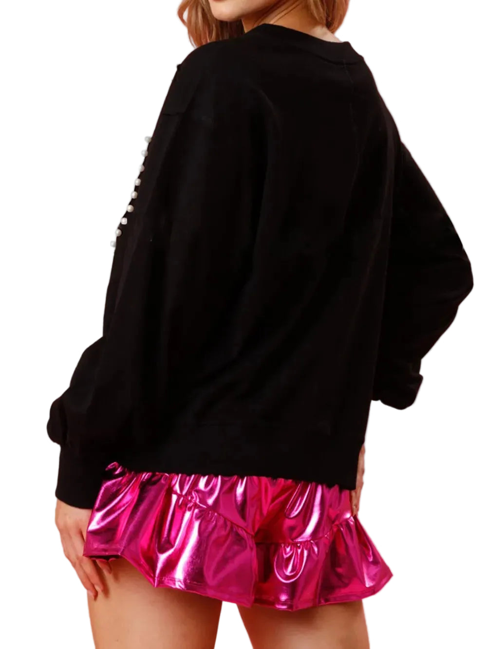 Back view of a black long-sleeve sweatshirt worn with a metallic pink skirt.