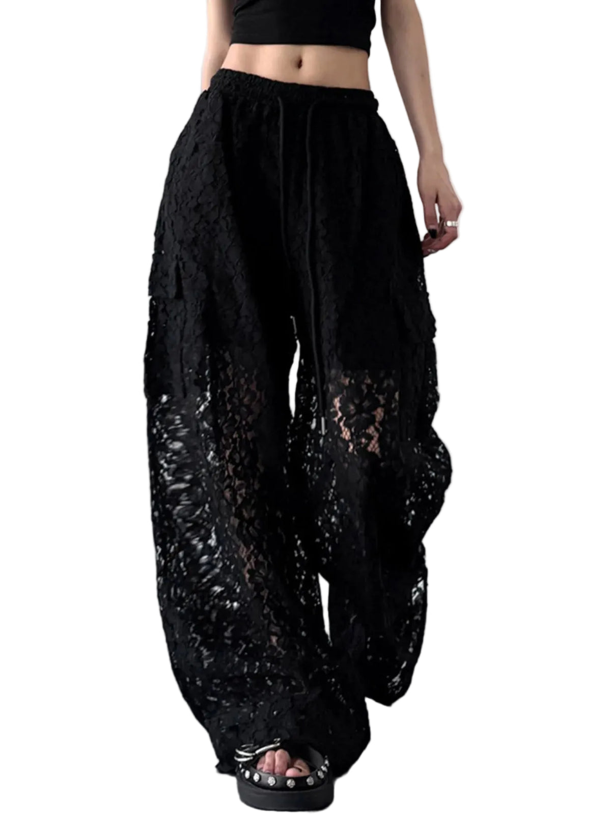 Front view of black floral lace wide-leg pants worn with platform sandals.